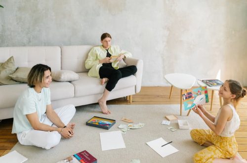 A family enjoying creative activities together in a bright living room setting.